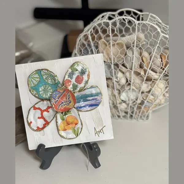 A six-petal shell flower wall art with teal fan, pineapple, and citrus patterns around an orange elephant center.