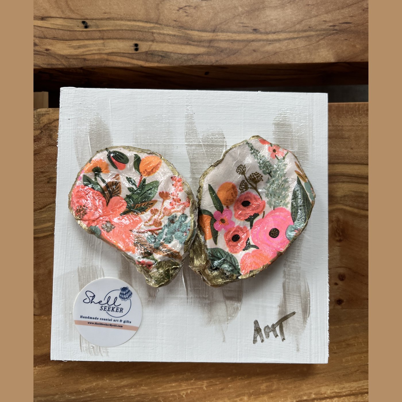 Two oyster shells forming a heart, decorated in a garden floral pattern.