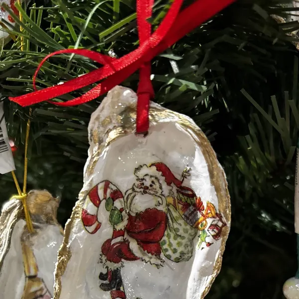 An oyster shell ornament with Santa Claus.