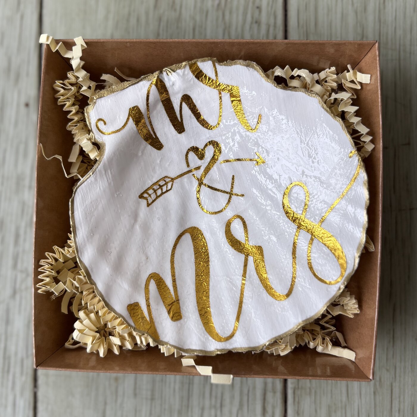 A shell dish hand-lettered in gold with "Mr & Mrs," perfect for a wedding gift. Comes in a gift box.